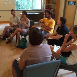 Deep Canvassers sit in a semi-circle and debrief about their experiences