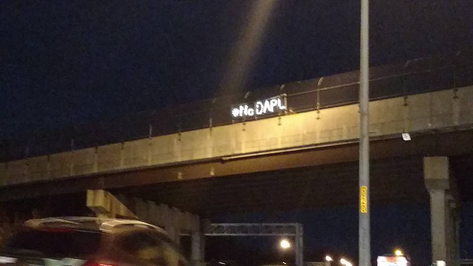 #noDAPL sign over Route 66 in the dark