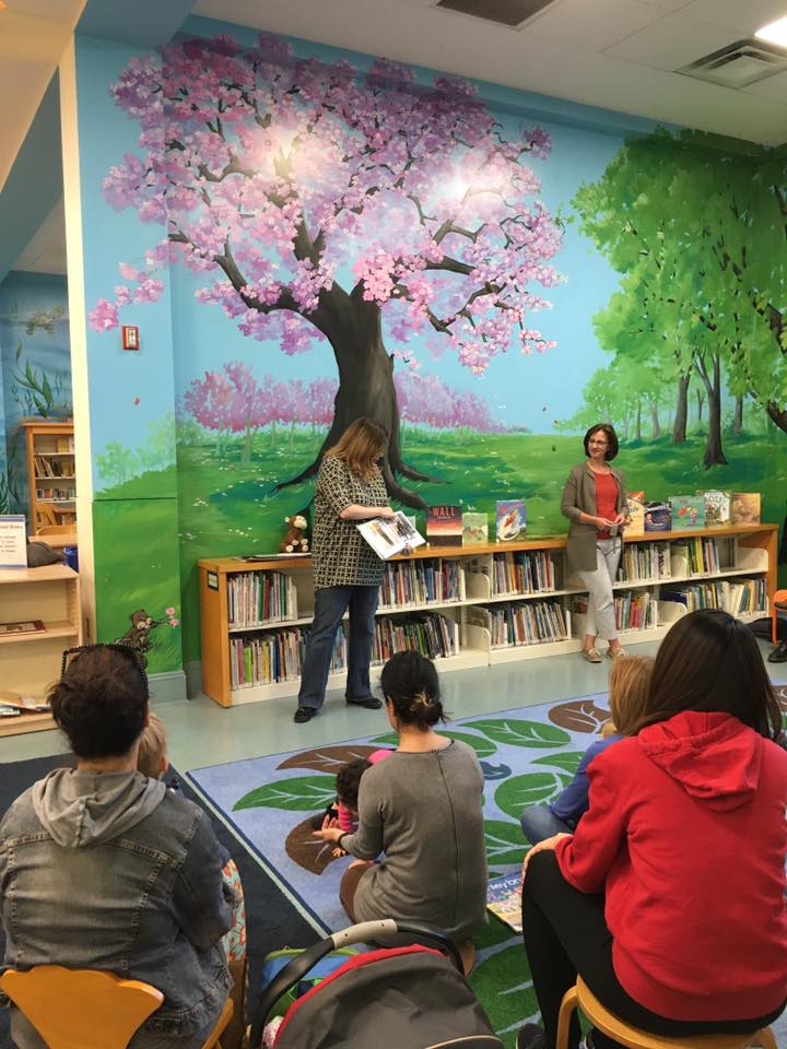 Parents with children at a racial justice story time at the library